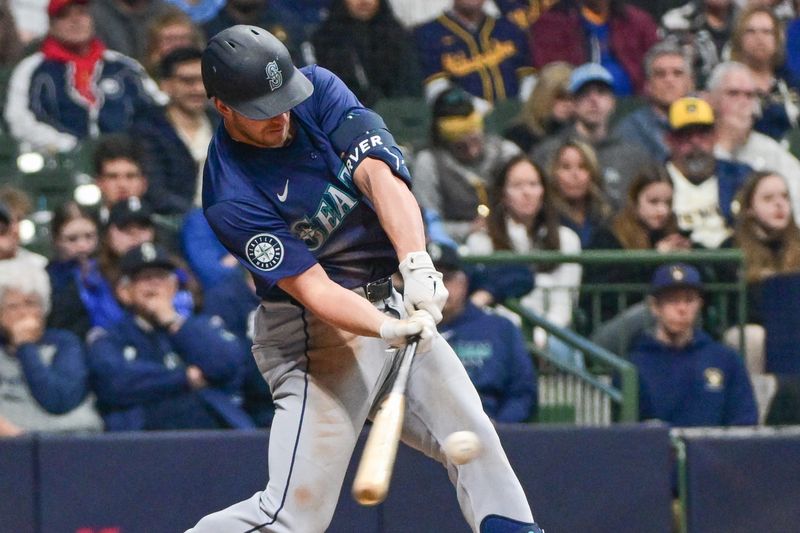 Apr 5, 2024; Milwaukee, Wisconsin, USA; Seattle Mariners designated hitter Mitch Garver (18) drives in a run with a sacrifice fly in the sixth inning against the Milwaukee Brewers at American Family Field. Mandatory Credit: Benny Sieu-USA TODAY Sports