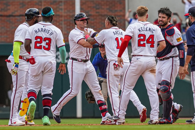 Apr 26, 2024; Cumberland, Georgia, USA; Atlanta Braves third baseman Austin Riley (27) reacts with shortstop Orlando Arcia (11) after hitting the game winning single against the Cleveland Guardians during the tenth inning at Truist Park. Mandatory Credit: Dale Zanine-USA TODAY Sports