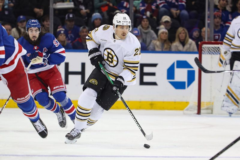 Nov 25, 2023; New York, New York, USA; Boston Bruins left wing James van Riemsdyk (21) skates the puck up ice against the New York Rangers during the first period at Madison Square Garden. Mandatory Credit: Danny Wild-USA TODAY Sports