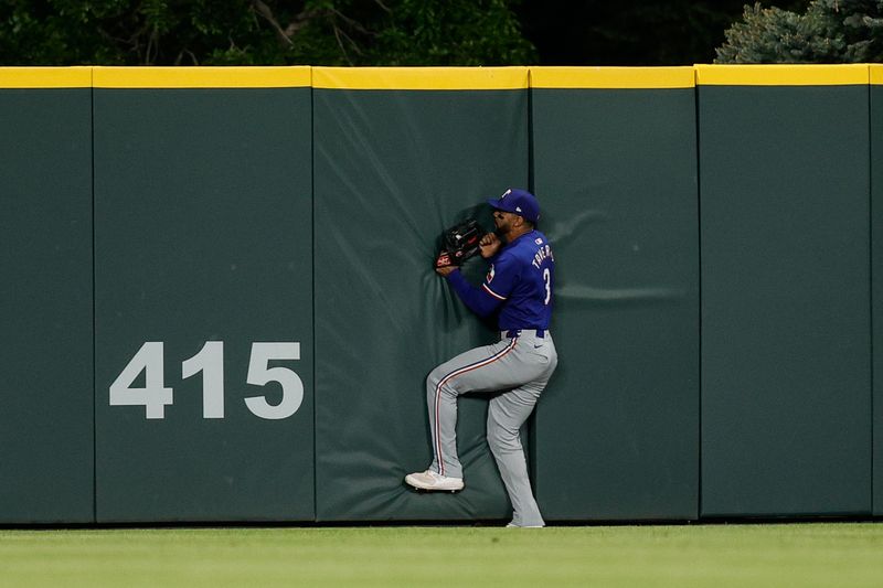 May 10, 2024; Denver, Colorado, USA; Texas Rangers center fielder Leody Taveras (3) makes a catch at the fence in the seventh inning against the Colorado Rockies at Coors Field. Mandatory Credit: Isaiah J. Downing-USA TODAY Sports