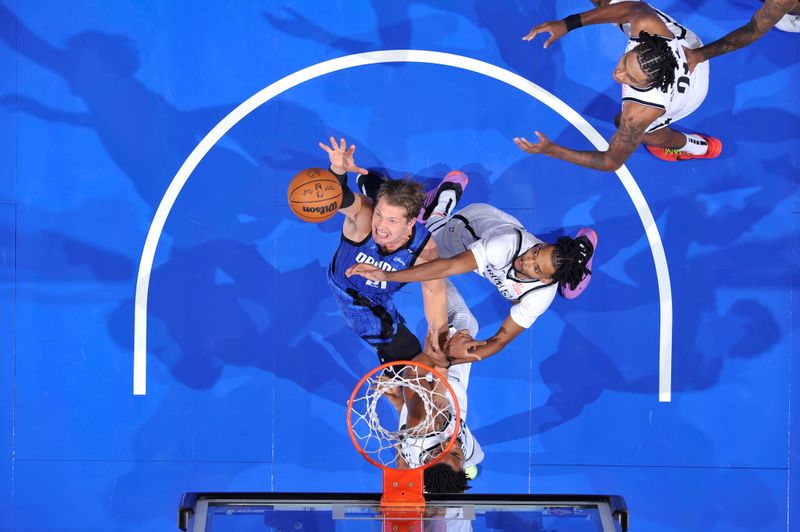 ORLANDO, FL - OCTOBER 25: Moritz Wagner #21 of the Orlando Magic rebounds the ball during the game against the Brooklyn Nets on October 25, 2024 at Kia Center in Orlando, Florida. NOTE TO USER: User expressly acknowledges and agrees that, by downloading and or using this photograph, User is consenting to the terms and conditions of the Getty Images License Agreement. Mandatory Copyright Notice: Copyright 2024 NBAE (Photo by Fernando Medina/NBAE via Getty Images)