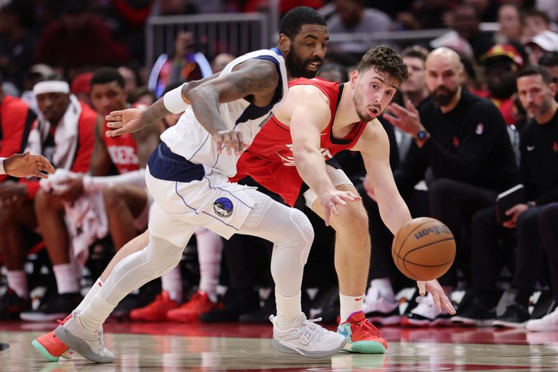 HOUSTON, TEXAS - JANUARY 01: Alperen Sengun #28 of the Houston Rockets goes for a loose ball against Kyrie Irving #11 of the Dallas Mavericks during the second half at Toyota Center on January 01, 2025 in Houston, Texas. NOTE TO USER: User expressly acknowledges and agrees that, by downloading and or using this photograph, User is consenting to the terms and conditions of the Getty Images License Agreement. (Photo by Alex Slitz/Getty Images)