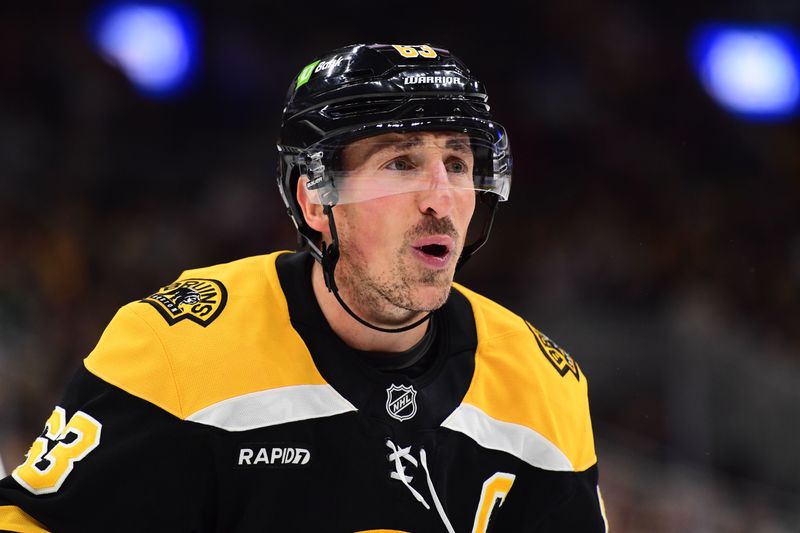 Oct 24, 2024; Boston, Massachusetts, USA;  Boston Bruins left wing Brad Marchand (63) has words with the referee after being called for a cross checking penalty during the third period against the Dallas Stars at TD Garden. Mandatory Credit: Bob DeChiara-Imagn Images