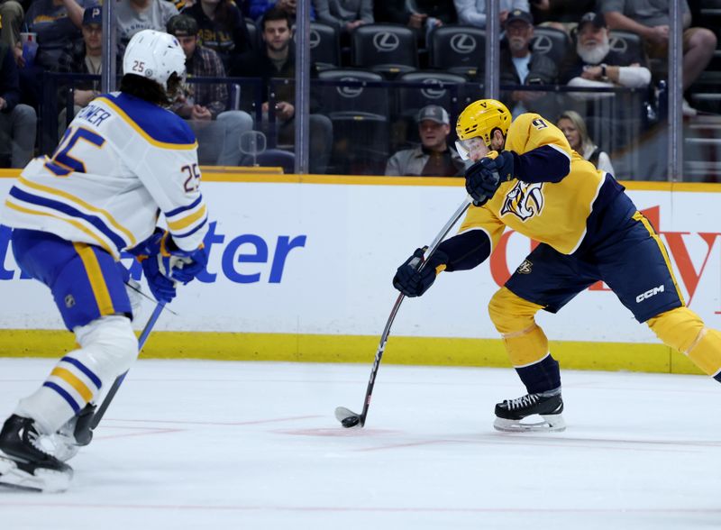 Mar 7, 2024; Nashville, Tennessee, USA; Nashville Predators left wing Filip Forsberg (9) shoots past Buffalo Sabres defenseman Owen Power (25) at Bridgestone Arena. Mandatory Credit: Alan Poizner-USA TODAY Sports