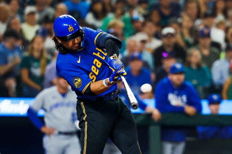 Aug 25, 2023; Seattle, Washington, USA; Seattle Mariners third baseman Eugenio Suarez (28) hits a two-run single against the Kansas City Royals during the fourth inning at T-Mobile Park. Mandatory Credit: Joe Nicholson-USA TODAY Sports