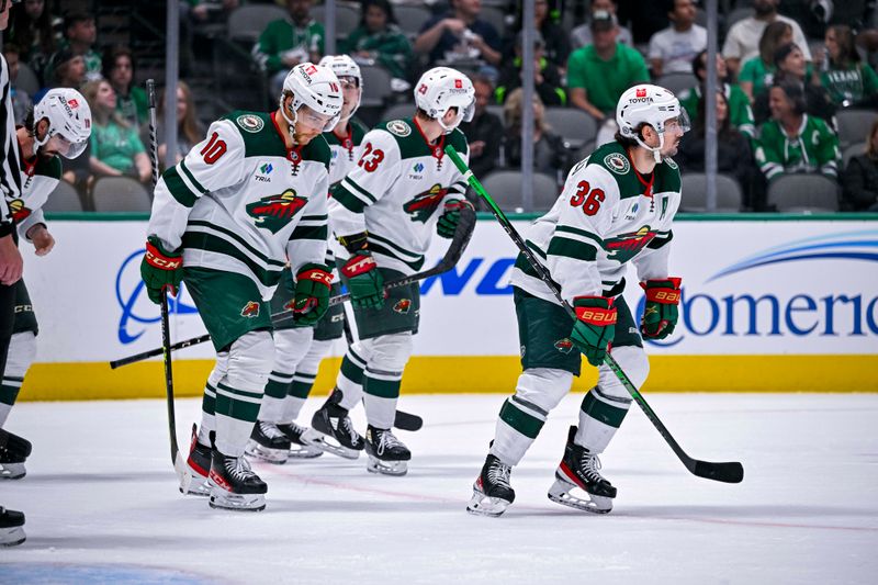 Sep 29, 2022; Dallas, Texas, USA; Minnesota Wild center Tyson Jost (10) and center Marco Rossi (23) and right wing Mats Zuccarello (36) skate off the ice aft Zuccarello scores a power play goal against the Dallas Stars during the first period at the American Airlines Center. Mandatory Credit: Jerome Miron-USA TODAY Sports