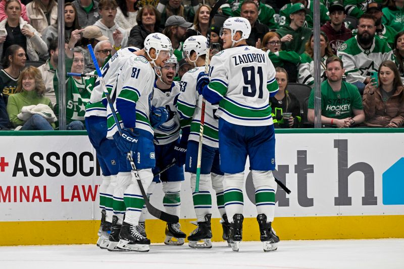 Dec 21, 2023; Dallas, Texas, USA; Vancouver Canucks right wing Conor Garland (8) and center Dakota Joshua (81) and center Teddy Blueger (53) and defenseman Nikita Zadorov (91) celebrates a goal scored by Garland against the Dallas Stars during the third period at the American Airlines Center. Mandatory Credit: Jerome Miron-USA TODAY Sports