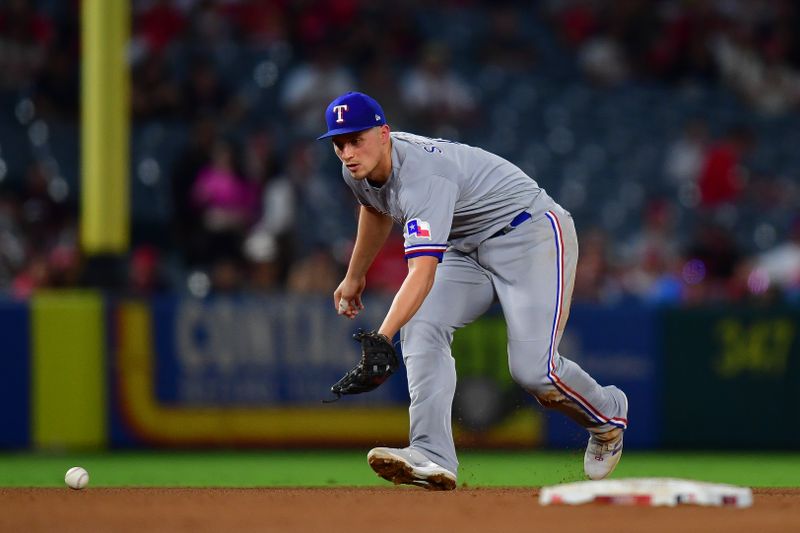 Sep 26, 2023; Anaheim, California, USA;  Texas Rangers shortstop Corey Seager (5) fields the ground ball of Los Angeles Angels first baseman Brandon Drury (23) during the third inning at Angel Stadium. Mandatory Credit: Gary A. Vasquez-USA TODAY Sports