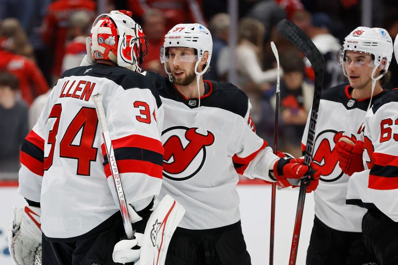 Nov 23, 2024; Washington, District of Columbia, USA; New Jersey Devils goaltender Jake Allen (34) celebrates with Devils center Justin Dowling (37) after their game against the Washington Capitals at Capital One Arena. Mandatory Credit: Geoff Burke-Imagn Images