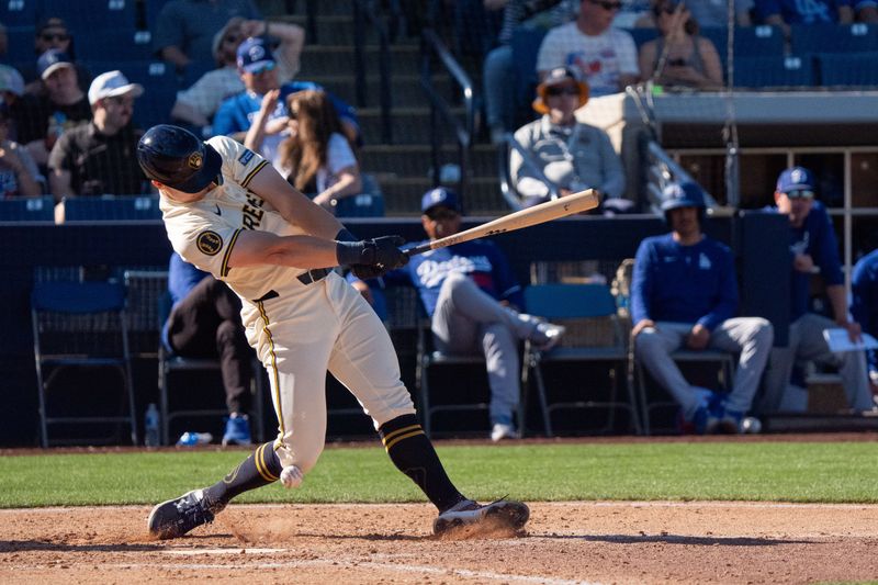 Mar 2, 2024; Phoenix, Arizona, USA; Milwaukee Brewers outfielder Joey Wiemer (28) gets hit in the knee after the ball deflected off his bat in the seventh during a spring training game against the Los Angeles Dodgers at American Family Fields of Phoenix. Mandatory Credit: Allan Henry-USA TODAY Sports