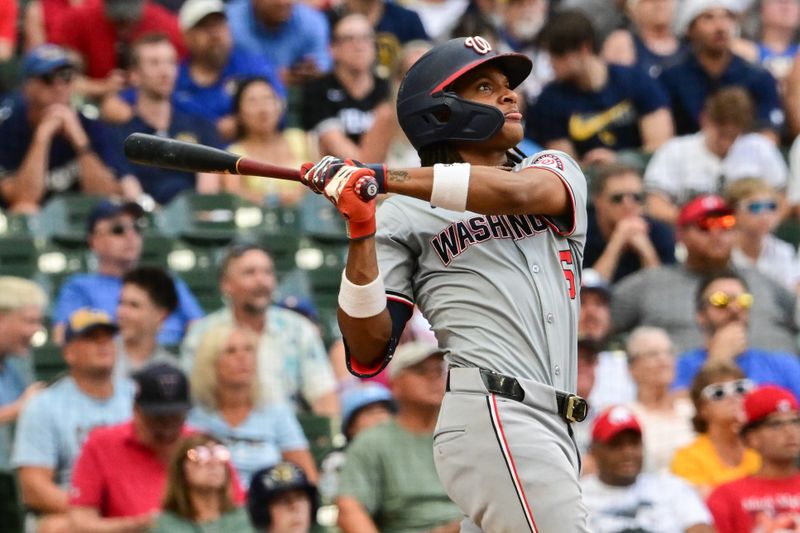 Jul 13, 2024; Milwaukee, Wisconsin, USA; Washington Nationals shortstop C.J. Abrams (5) hits a 2-run home run against the Milwaukee Brewers in the ninth inning at American Family Field. Mandatory Credit: Benny Sieu-USA TODAY Sports