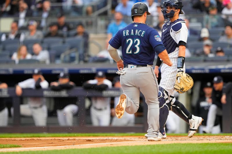 Jun 22, 2023; Bronx, New York, USA; Seattle Mariners first baseman Ty France (23) scores a run on Seattle Mariners third baseman Eugenio Suarez (not pictured) RBI double against the New York Yankees during the first inning at Yankee Stadium. Mandatory Credit: Gregory Fisher-USA TODAY Sports