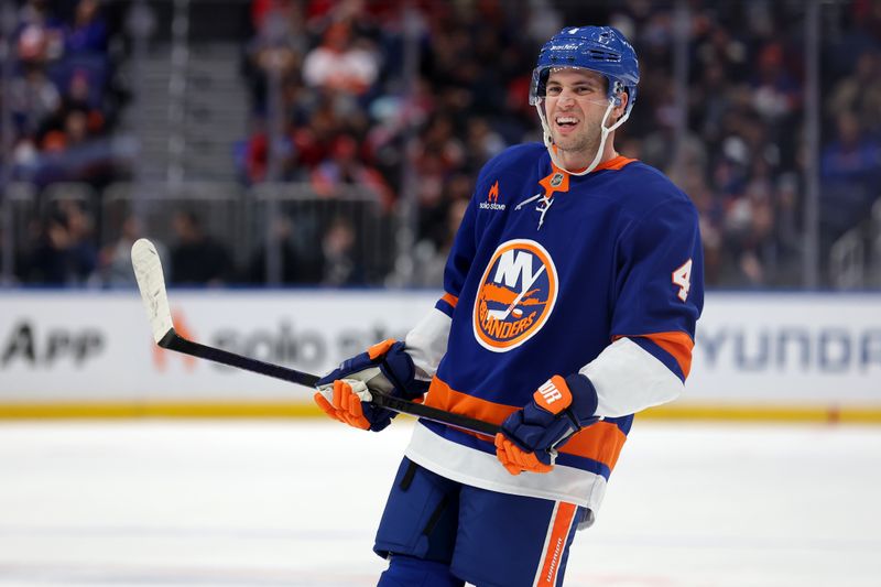 Jan 25, 2025; Elmont, New York, USA; New York Islanders defenseman Tony DeAngelo (4) reacts during the first period against the Carolina Hurricanes at UBS Arena. Mandatory Credit: Brad Penner-Imagn Images