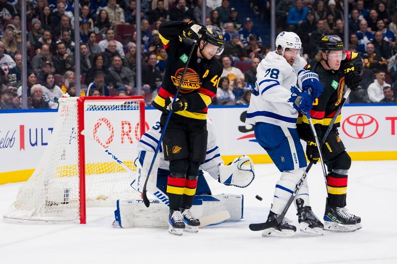 Jan 20, 2024; Vancouver, British Columbia, CAN; Toronto Maple Leafs goalie Martin Jones (31) watches as Vancouver Canucks forward Elias Pettersson (40) and forward Brock Boeser (6) battle with defenseman TJ Brodie (78) in the first period at Rogers Arena. Mandatory Credit: Bob Frid-USA TODAY Sports