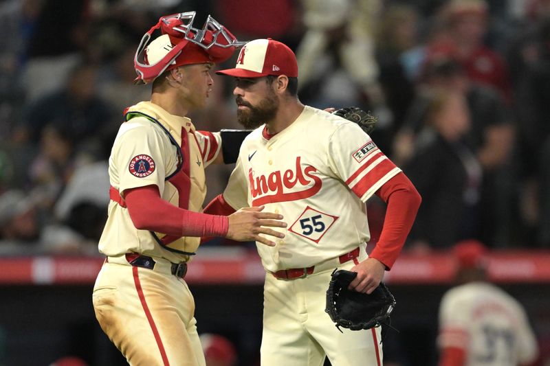 Jun 5, 2024; Anaheim, California, USA;  Los Angeles Angels relief pitcher Matt Moore (55) is congratulated by catcher Logan O'Hoppe (14) after a save in the ninth inning against the San Diego Padres at Angel Stadium. Mandatory Credit: Jayne Kamin-Oncea-USA TODAY Sports