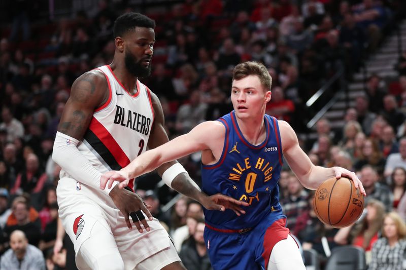 PORTLAND, OREGON - FEBRUARY 23: Christian Braun #0 of the Denver Nuggets drives to the basket as Deandre Ayton #2 of the Portland Trail Blazers defends during the fourth quarter at Moda Center on February 23, 2024 in Portland, Oregon. NOTE TO USER: User expressly acknowledges and agrees that, by downloading and or using this photograph, User is consenting to the terms and conditions of the Getty Images License Agreement.? (Photo by Amanda Loman/Getty Images)