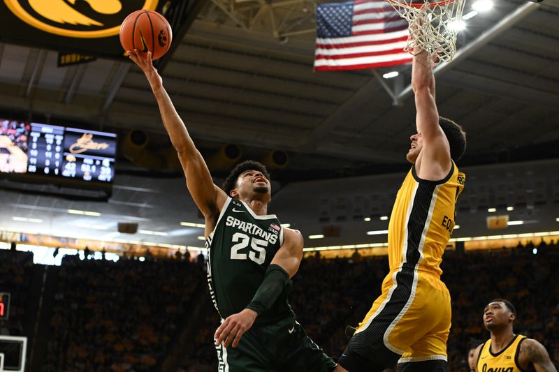 Feb 25, 2023; Iowa City, Iowa, USA; Michigan State Spartans forward Malik Hall (25) goes to the basket as Iowa Hawkeyes forward Filip Rebraca (0) defends during the first half at Carver-Hawkeye Arena. Mandatory Credit: Jeffrey Becker-USA TODAY Sports