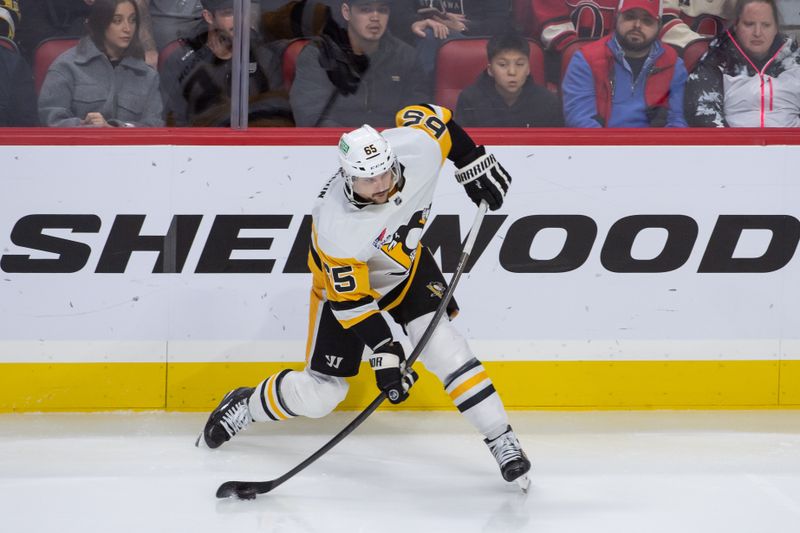 Dec 23, 2023; Ottawa, Ontario, CAN; Pittsburgh Penguins defenseman Erik Karlsson (65) shoots the puck in the third period against the Ottawa Senators at the Canadian Tire Centre. Mandatory Credit: Marc DesRosiers-USA TODAY Sports