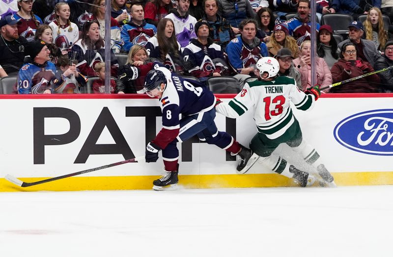 Jan 20, 2025; Denver, Colorado, USA; Minnesota Wild center Yakov Trenin (13) and Colorado Avalanche defenseman Cale Makar (8) during the first period at Ball Arena. Mandatory Credit: Ron Chenoy-Imagn Images