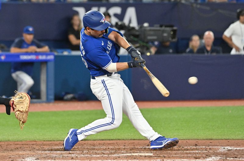 Aug 26, 2023; Toronto, Ontario, CAN;  Toronto Blue Jays second baseman Davis Schneider (36) hits an RBI single against the Cleveland Guardians in the seventh inning at Rogers Centre. Mandatory Credit: Dan Hamilton-USA TODAY Sports