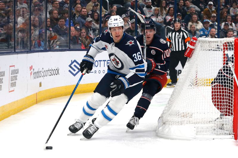 Nov 1, 2024; Columbus, Ohio, USA; Winnipeg Jets center Morgan Barron (36) looks to pass as Columbus Blue Jackets left wing Dmitri Voronkov (10) trails the play during the first period at Nationwide Arena. Mandatory Credit: Russell LaBounty-Imagn Images