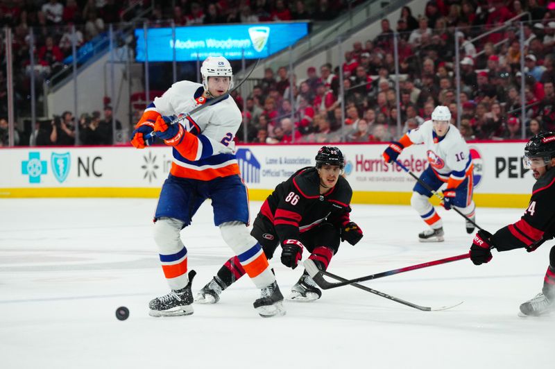 Apr 30, 2024; Raleigh, North Carolina, USA; New York Islanders defenseman Mike Reilly (2) clears the puck away from Carolina Hurricanes left wing Teuvo Teravainen (86) during the second period in game five of the first round of the 2024 Stanley Cup Playoffs at PNC Arena. Mandatory Credit: James Guillory-USA TODAY Sports