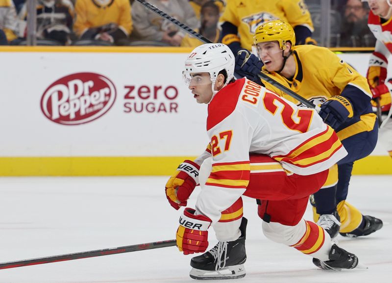 Nov 1, 2025; Nashville, Tennessee, USA; Nashville Predators right wing Matthew Wood (71) shoots the puck and scores a goal against Calgary Flames right wing Matt Coronato (27) during the first period at Bridgestone Arena. Mandatory Credit: Alan Poizner-Imagn Images