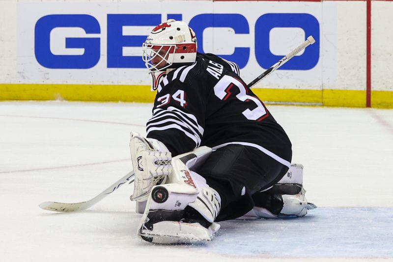 Mar 23, 2024; Newark, New Jersey, USA; New Jersey Devils goaltender Jake Allen (34) makes a save against the Ottawa Senators during the third period at Prudential Center. Mandatory Credit: Ed Mulholland-USA TODAY Sports