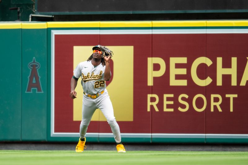 Oct 1, 2023; Anaheim, California, USA; Oakland Athletics center fielder Lawrence Butler (22) makes a catch against the Los Angeles Angels during the third inning at Angel Stadium. Mandatory Credit: Jonathan Hui-USA TODAY Sports