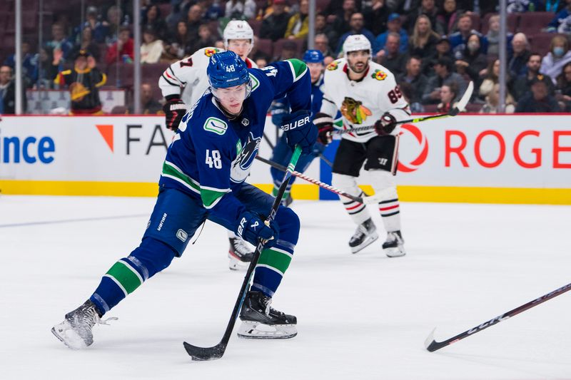 Apr 6, 2023; Vancouver, British Columbia, CAN; Vancouver Canucks defenseman Cole McWard (48) handles the puck against the Chicago Blackhawks in the third period at Rogers Arena. Canucks won 3-0. Mandatory Credit: Bob Frid-USA TODAY Sports