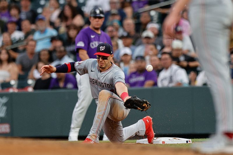 Jun 21, 2024; Denver, Colorado, USA; Washington Nationals first baseman Joey Meneses (45) is unable to field a throw in the fourth inning against the Colorado Rockies at Coors Field. Mandatory Credit: Isaiah J. Downing-USA TODAY Sports