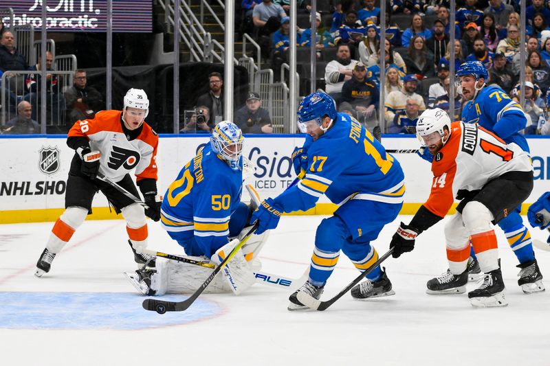 Nov 14, 2025; St. Louis, Missouri, USA; St. Louis Blues defenseman Cam Fowler (17) clears the puck from the crease during the first period against the Philadelphia Flyers at Enterprise Center. Mandatory Credit: Jeff Curry-Imagn Images