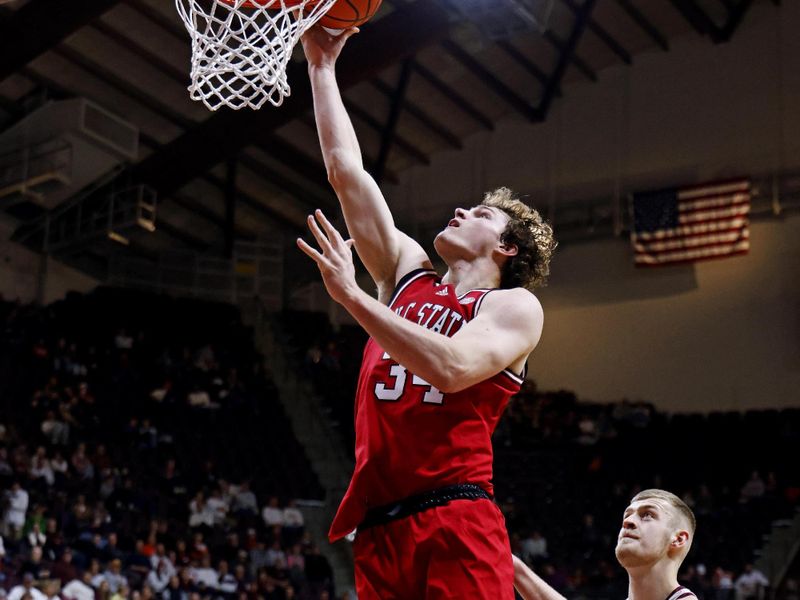 Jan 15, 2025; Blacksburg, Virginia, USA; North Carolina State Wolfpack forward Ben Middlebrooks (34) shoots the ball against Virginia Tech Hokies center Patrick Wessler (5) during the second half at Cassell Coliseum. Mandatory Credit: Peter Casey-Imagn Images