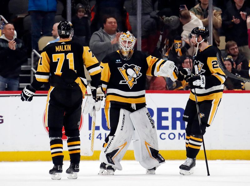 Jan 15, 2024; Pittsburgh, Pennsylvania, USA;  Pittsburgh Penguins goaltender Tristan Jarry (35) celebrates his shutout victory with center Evgeni Malkin (71) and defenseman Marcus Pettersson (28) after defeating the Seattle Kraken at PPG Paints Arena. Mandatory Credit: Charles LeClaire-USA TODAY Sports