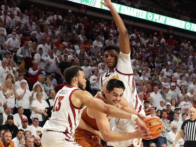 Jan 17, 2023; Ames, Iowa, USA; Texas Longhorns forward Brock Cunningham (30) splits the defense of Iowa State Cyclones guard Jaren Holmes (13) and center Osun Osunniyi (21) during the second half at James H. Hilton Coliseum. Mandatory Credit: Reese Strickland-USA TODAY Sports