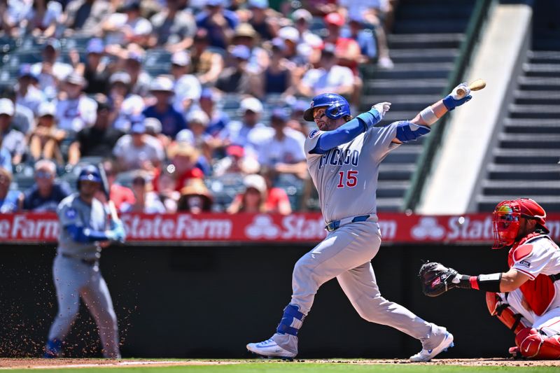 Aug 24, 2025; Anaheim, California, USA; Chicago Cubs catcher Carson Kelly (15) forced out at first base against Los Angeles Angels catcher Travis d'Arnaud (25) during the second inning at Angel Stadium. Mandatory Credit: Jonathan Hui-Imagn Images
