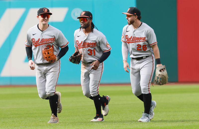 Sep 24, 2023; Cleveland, Ohio, USA; Baltimore Orioles left fielder Austin Hays (21), center fielder Cedric Mullins (31)and right fielder Ryan McKenna (26) run off the field after defeating the Cleveland Guardians 5-1 at Progressive Field. Mandatory Credit: Aaron Josefczyk-USA TODAY Sports