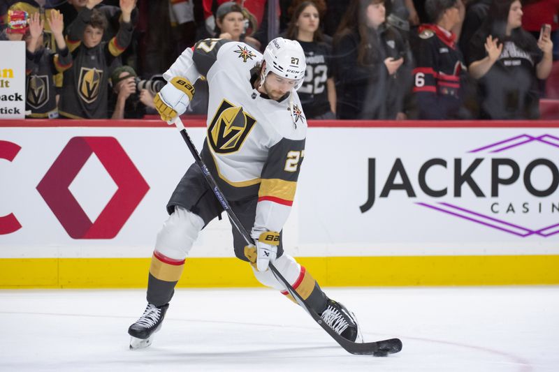 Feb 24, 2024; Ottawa, Ontario, CAN; Vegas Golden Knights defenseman Shea Theodore (27) shoots the puck during warmup prior to the start of game against the Ottawa Senators at the Canadian Tire Centre. Mandatory Credit: Marc DesRosiers-USA TODAY Sports