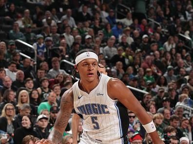 MILWAUKEE, WI - DECEMBER 21: Paolo Banchero #5 of the Orlando Magic handles the ball during the game against the Milwaukee Bucks on December 21, 2023 at the Fiserv Forum Center in Milwaukee, Wisconsin. NOTE TO USER: User expressly acknowledges and agrees that, by downloading and or using this Photograph, user is consenting to the terms and conditions of the Getty Images License Agreement. Mandatory Copyright Notice: Copyright 2023 NBAE (Photo by Gary Dineen/NBAE via Getty Images).