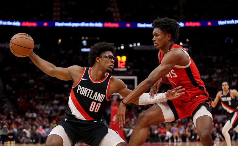 HOUSTON, TEXAS - MARCH 25: Scoot Henderson #00 of the Portland Trail Blazers controls the ball against Amen Thompson #1 of the Houston Rockets in the first half at Toyota Center on March 25, 2024 in Houston, Texas.  NOTE TO USER: User expressly acknowledges and agrees that, by downloading and or using this photograph, User is consenting to the terms and conditions of the Getty Images License Agreement. (Photo by Tim Warner/Getty Images)