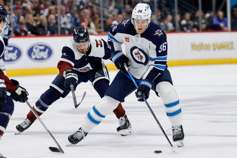 Apr 13, 2024; Denver, Colorado, USA; Winnipeg Jets center Morgan Barron (36) controls the puck under pressure from Colorado Avalanche right wing Valeri Nichushkin (13) in the first period at Ball Arena. Mandatory Credit: Isaiah J. Downing-USA TODAY Sports