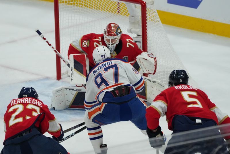 Jun 8, 2024; Sunrise, Florida, USA; Florida Panthers forward Carter Verhaeghe (23) and goaltender Sergei Bobrovsky (72) defend against Edmonton Oilers forward Connor McDavid (97) during the first period in game one of the 2024 Stanley Cup Final at Amerant Bank Arena. Mandatory Credit: Jim Rassol-USA TODAY Sports