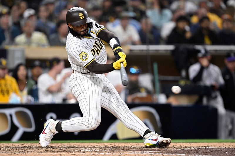 May 13, 2024; San Diego, California, USA; San Diego Padres catcher Luis Campusano (12) hits an RBI single against the Colorado Rockies during the seventh inning at Petco Park. Mandatory Credit: Orlando Ramirez-USA TODAY Sports