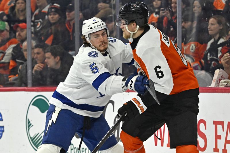 Jan 23, 2024; Philadelphia, Pennsylvania, USA; Tampa Bay Lightning defenseman Philippe Myers (5) checks Philadelphia Flyers defenseman Travis Sanheim (6) during the third period at Wells Fargo Center. Mandatory Credit: Eric Hartline-USA TODAY Sports