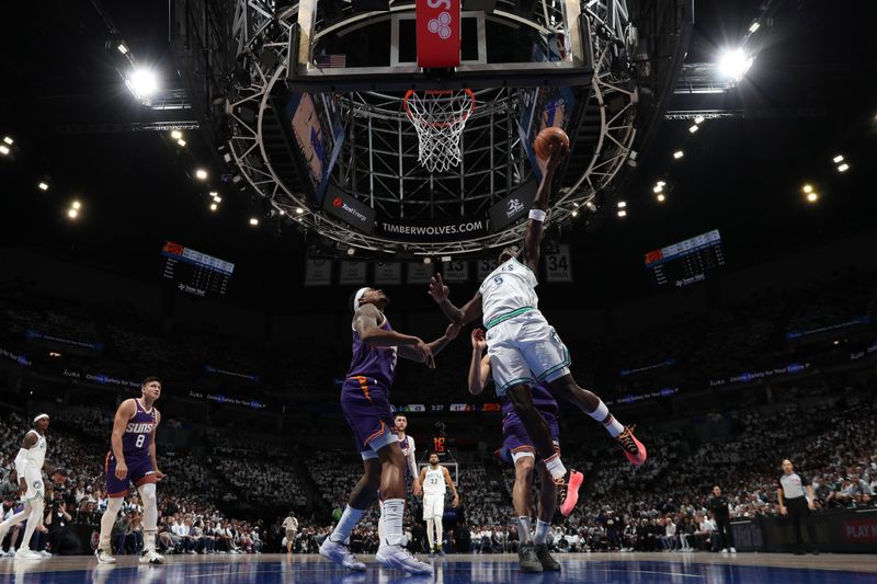 MINNEAPOLIS, MN -  APRIL 20: Anthony Edwards #5 of the Minnesota Timberwolves drives to the basket during Round One Game One of the 2024 NBA Playoffs against the Phoenix Suns on April 20, 2024 at Target Center in Minneapolis, Minnesota. NOTE TO USER: User expressly acknowledges and agrees that, by downloading and or using this Photograph, user is consenting to the terms and conditions of the Getty Images License Agreement. Mandatory Copyright Notice: Copyright 2024 NBAE (Photo by Jordan Johnson/NBAE via Getty Images)