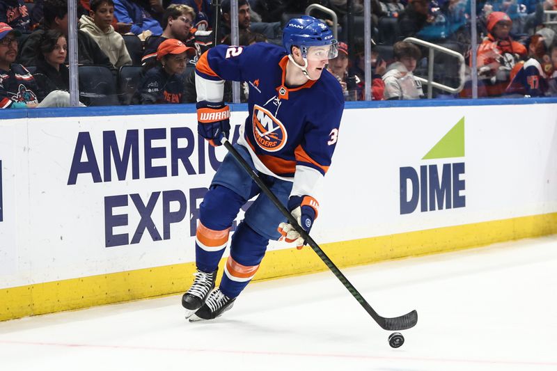 Oct 29, 2024; Elmont, New York, USA;  New York Islanders center Kyle MacLean (32) controls the puck in the third period against the Anaheim Ducks at UBS Arena. Mandatory Credit: Wendell Cruz-Imagn Images