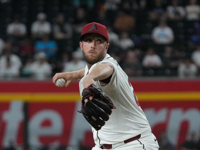 Jun 9, 2025; Phoenix, Arizona, USA; Arizona Diamondbacks pitcher Merrill Kelly (29) throws against the Seattle Mariners in the first inning at Chase Field. Mandatory Credit: Rick Scuteri-Imagn Images