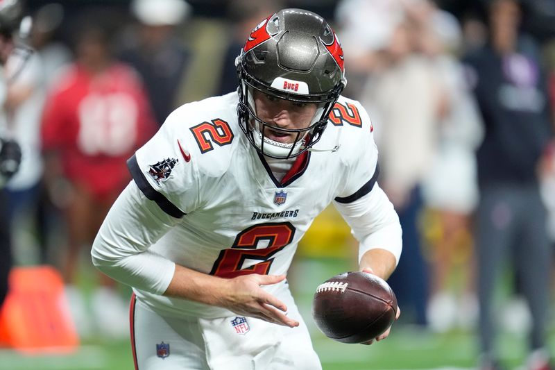 Tampa Bay Buccaneers quarterback Kyle Trask (2) warms up before an NFL football game against the New Orleans Saints in New Orleans, Sunday, Oct. 13, 2024. (AP Photo/Michael Conroy)