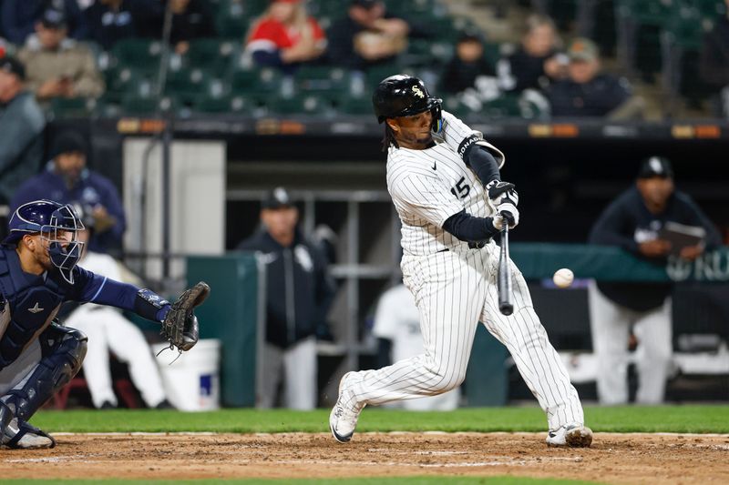 Apr 26, 2024; Chicago, Illinois, USA; Chicago White Sox catcher Martín Maldonado (15) hits a three-run home run against the Tampa Bay Rays during the sixth inning at Guaranteed Rate Field. Mandatory Credit: Kamil Krzaczynski-USA TODAY Sports