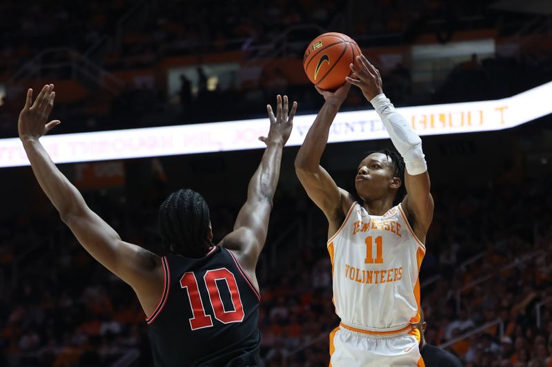 Jan 15, 2025; Knoxville, Tennessee, USA; Tennessee Volunteers guard Jordan Gainey (11) shoots against Georgia Bulldogs forward RJ Godfrey (10) during the first half at Thompson-Boling Arena at Food City Center. Mandatory Credit: Randy Sartin-Imagn Images